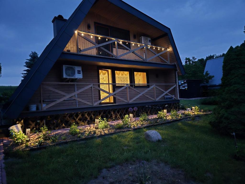 a house with lights on the front of it at Duchniczowe in Prusie