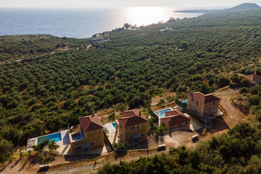an aerial view of a house on a hill next to the ocean at Aether Blue Eco Villas in Agios Nikolaos