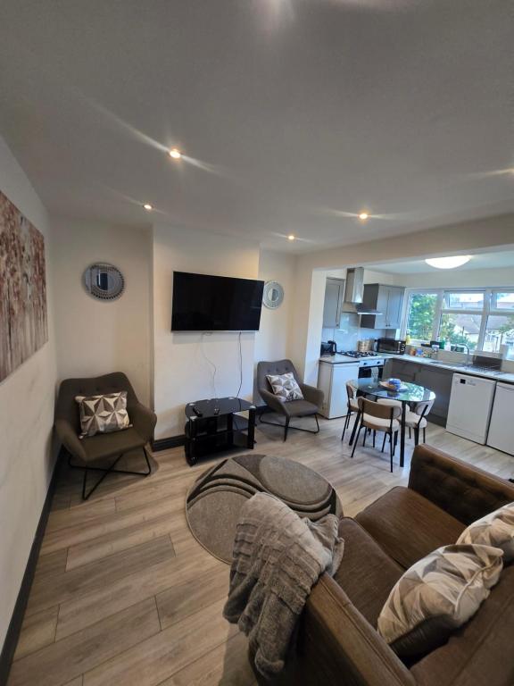 a living room with a couch and a table at White Shelf Dartford House in Kent