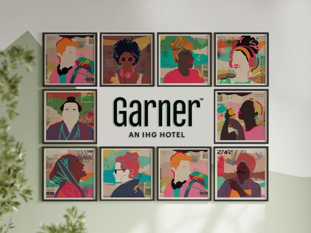 a group of framed portraits of people at Garner Hotel Wolverhampton by IHG in Wolverhampton