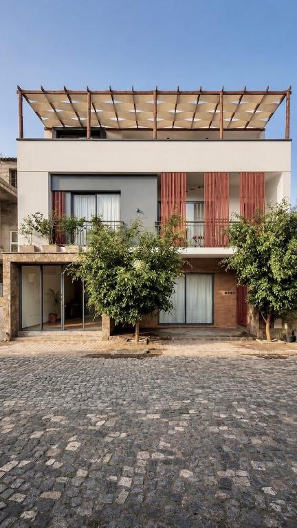 a building with two trees in front of it at Alfa-apartamento in Pombas