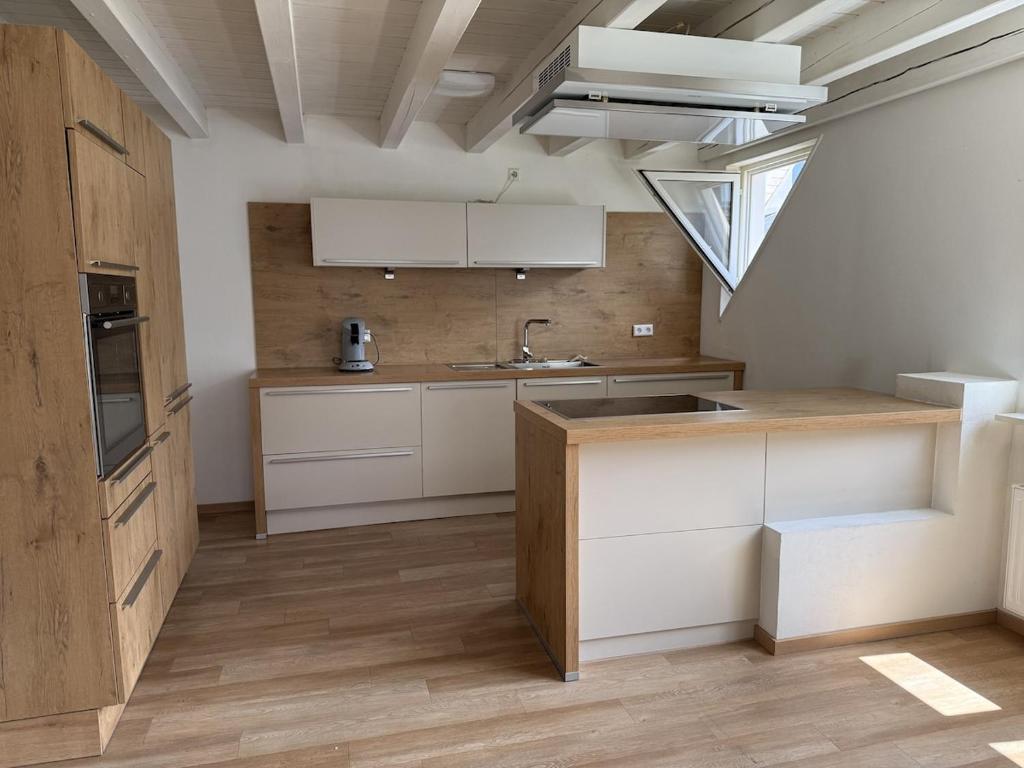 a kitchen with white cabinets and a sink at Boardinghouse Rheinfelden 4 in Rheinfelden