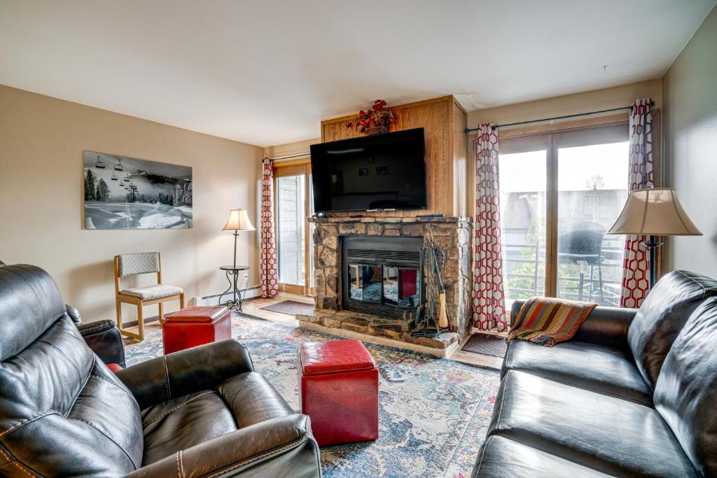 a living room with leather furniture and a fireplace at Silverthorne Condo: New Pool & Hot Tub + Fireplace in Silverthorne