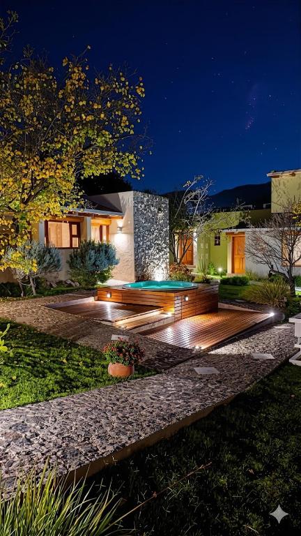 a house with a wooden deck at night at Al Sereno Hotel Spa in Tilcara