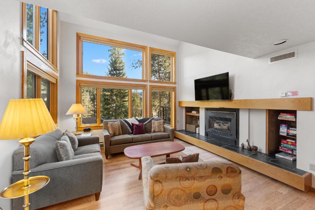 a living room with a couch and a fireplace at Quicksilver #1631 in Keystone