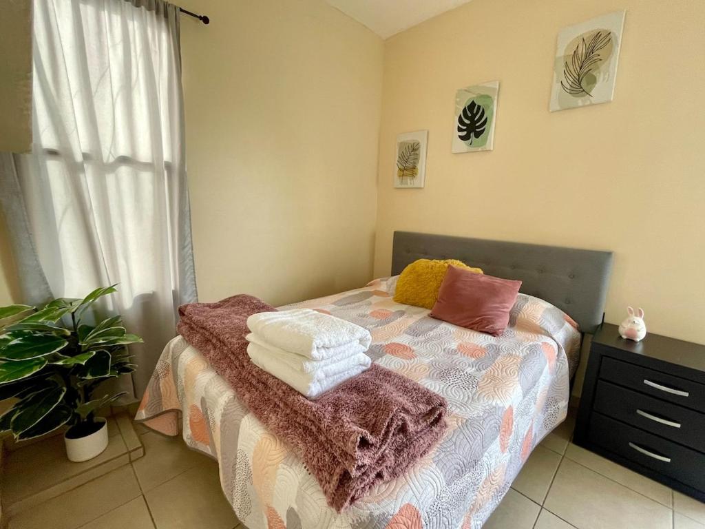 a bedroom with a bed with towels on it at Estudio #5 a 5 min del malecon in La Paz