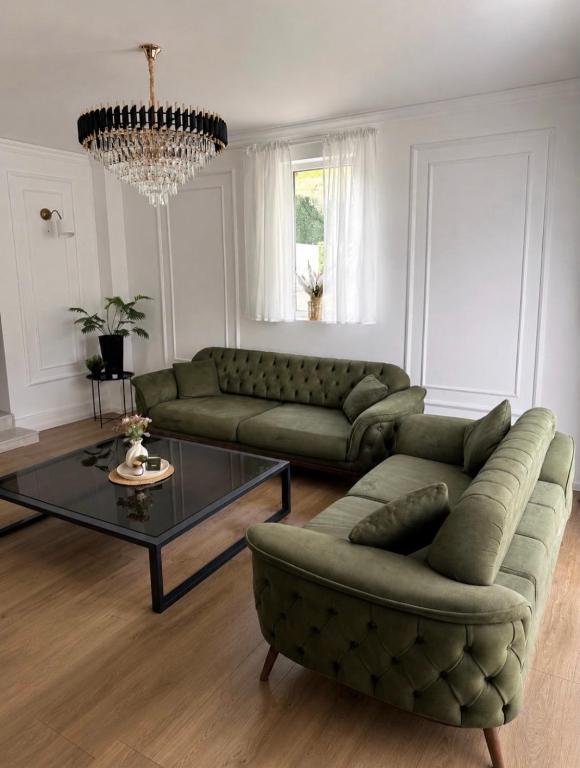 a living room with a couch and a coffee table at De Papel Villa in Jankoviči
