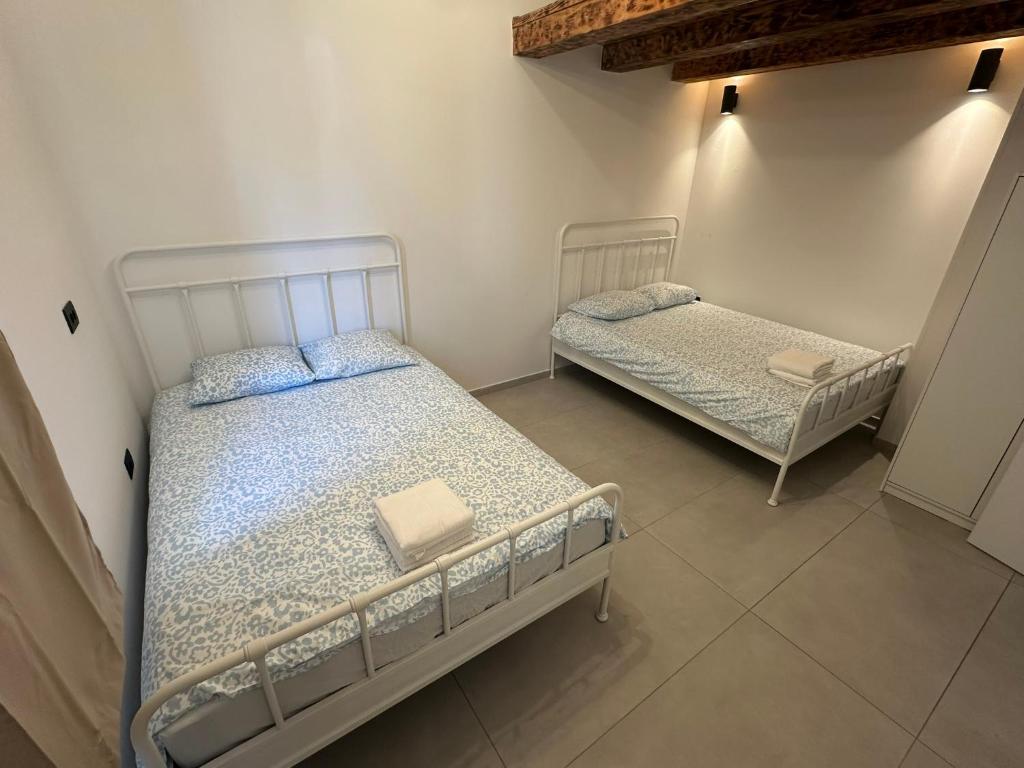 two twin beds in a room with at Apartment Dantéa Novéa - NEW 2026 in Izola