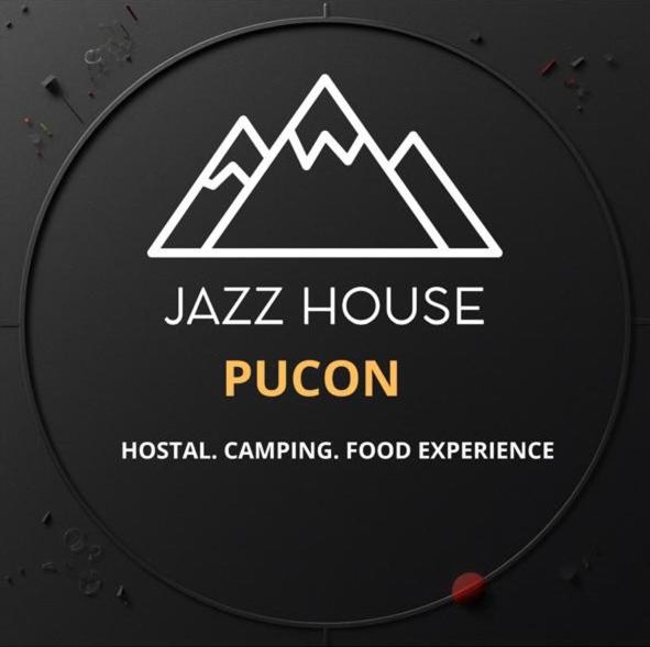 a sign for a jazz house puon with mountains at Jazz House Pucon in Pucón