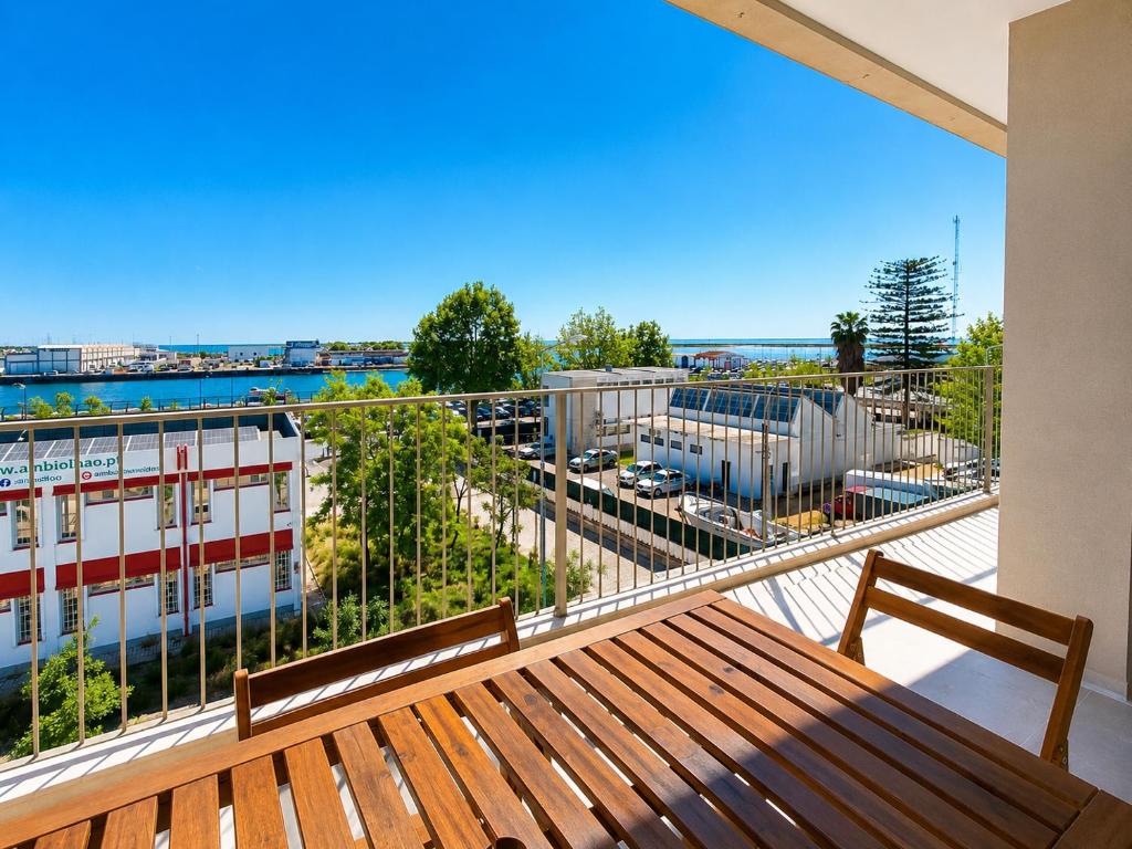 a balcony with a bench and a view of a building at Entrecubos Apartamentos in Olhão