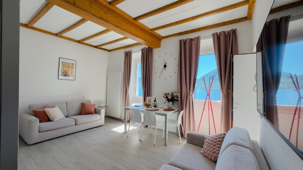 a living room with a couch and a table at Belvedere 237A Lakeview Luxury Apartment in Ghiffa