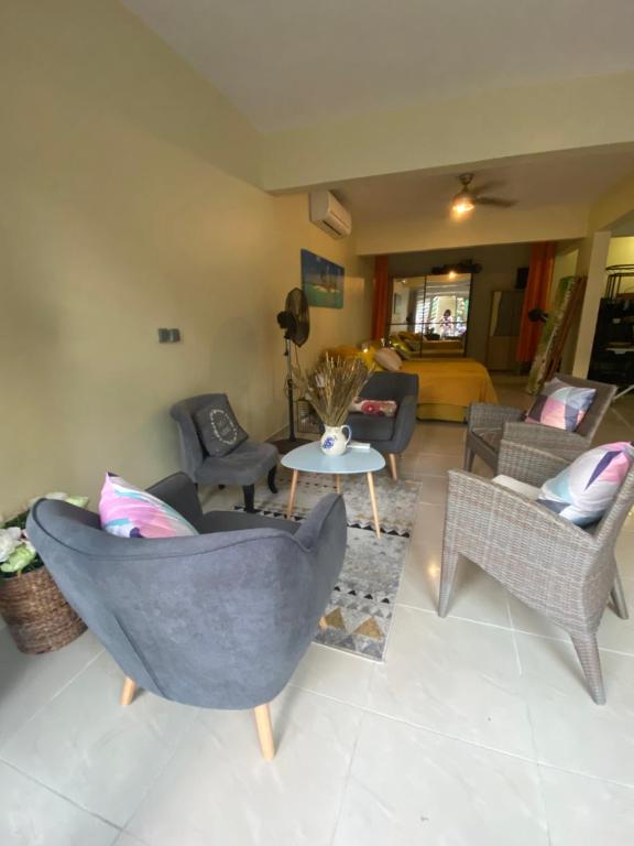 a living room with a couch and chairs and a table at Le loft Acajou in Le Lamentin