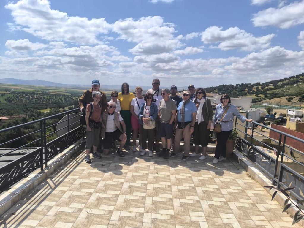 a group of people posing for a picture on top of a mountain at Gite El Menzeh in Moulay Idriss