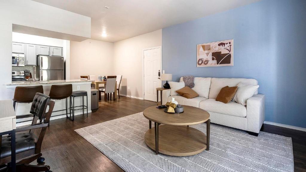 a living room with a white couch and a table at Landing Spectacular 1BD Pool Gym in San Antonio