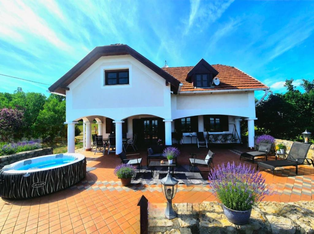 a house with a patio and a swimming pool at Dorono House in Balatonudvari