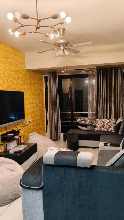 a living room with a couch and a tv at Coutinho BNB in Madgaon