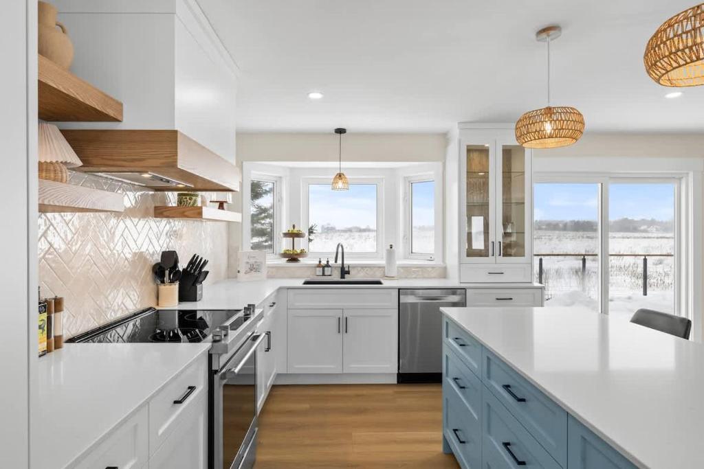 a kitchen with white countertops and a large island at The Lantern Hill Lookout in North Rustico