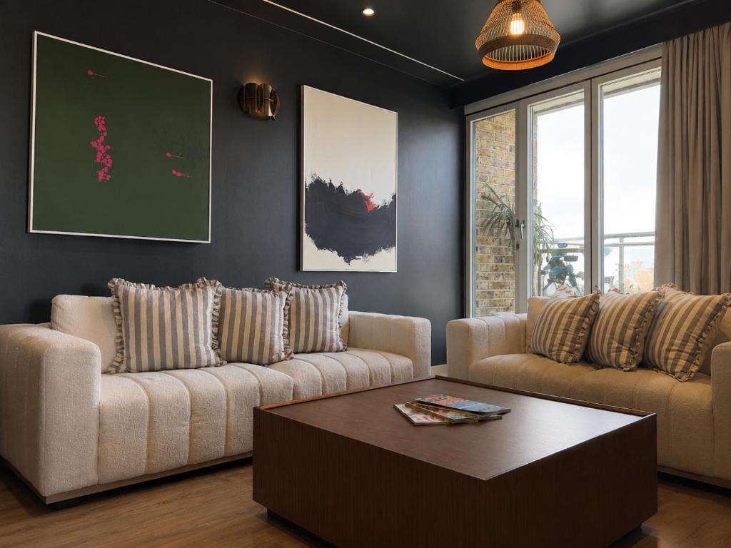 a living room with two couches and a coffee table at The Apex Penthouse, Hyde Park in London