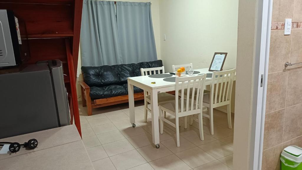a kitchen with a table and chairs and a couch at La Palmera in Chajarí