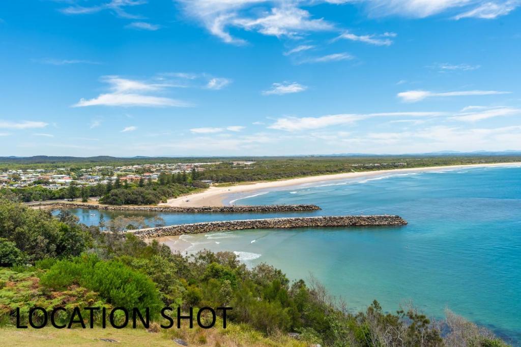 an aerial view of a beach and the ocean at River Cottage on Cherry - Pet Friendly in Evans Head