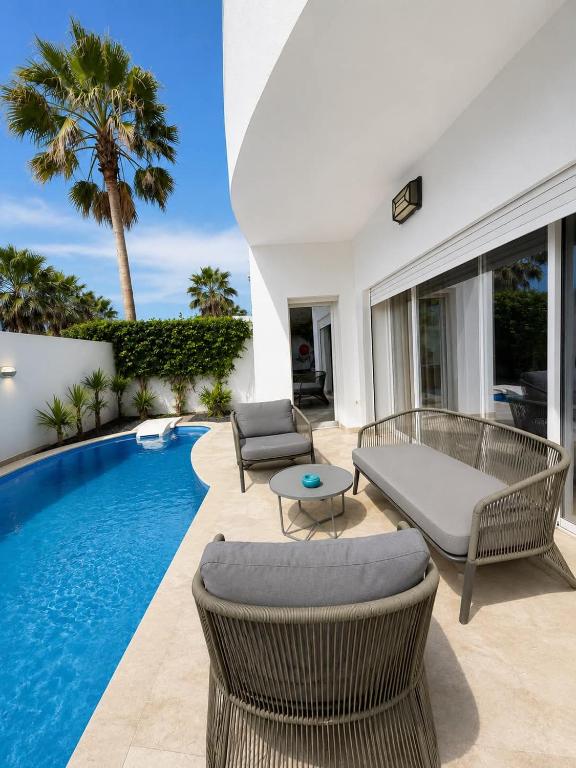 a villa with a swimming pool and a patio at Alya Residence in La Marsa