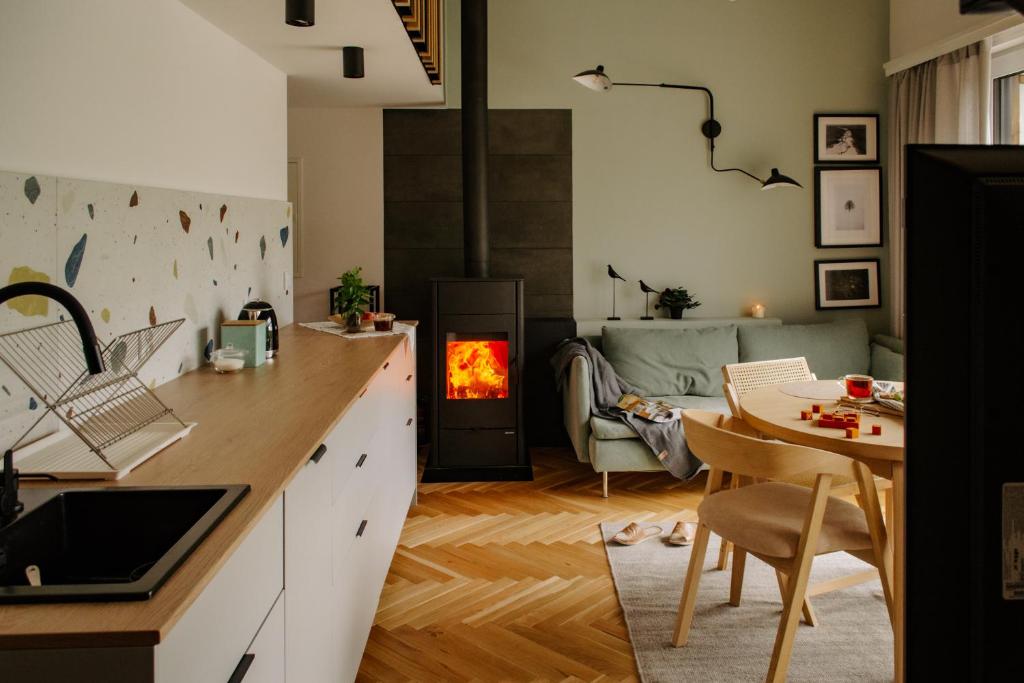 a kitchen with a table and a stove in a room at Nomad Cabin Roztocze in Tereszpol Zaorenda