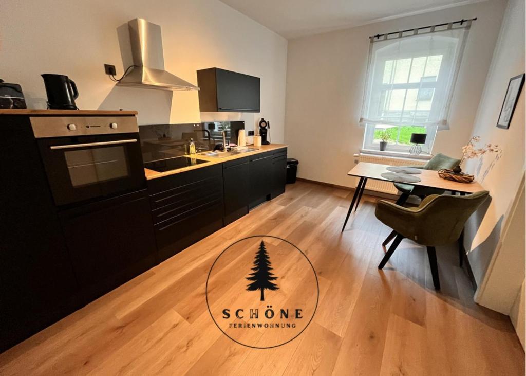 a kitchen with a stove and a table with a tree on it at Schöne Ferienwohnung in Beierfeld