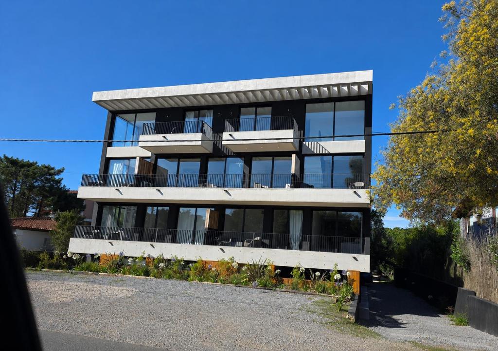 a large building with a lot of windows at Kilka Departamento 3 Ambientes con Balcón in Mar de las Pampas