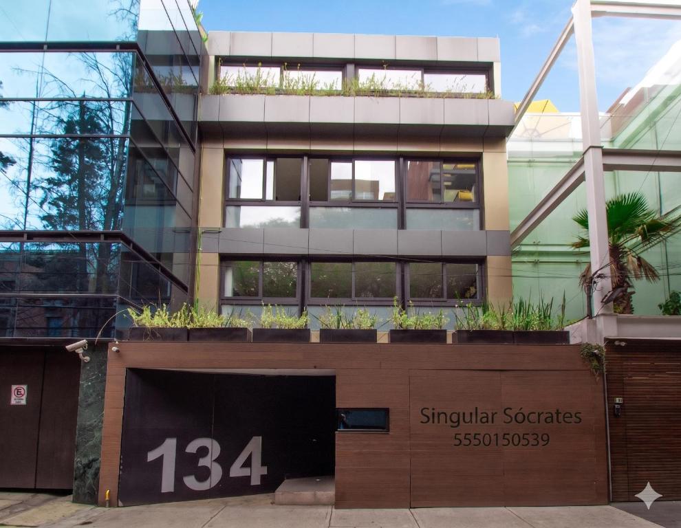 a building with plants on top of it at Singular Sócrates in Mexico City