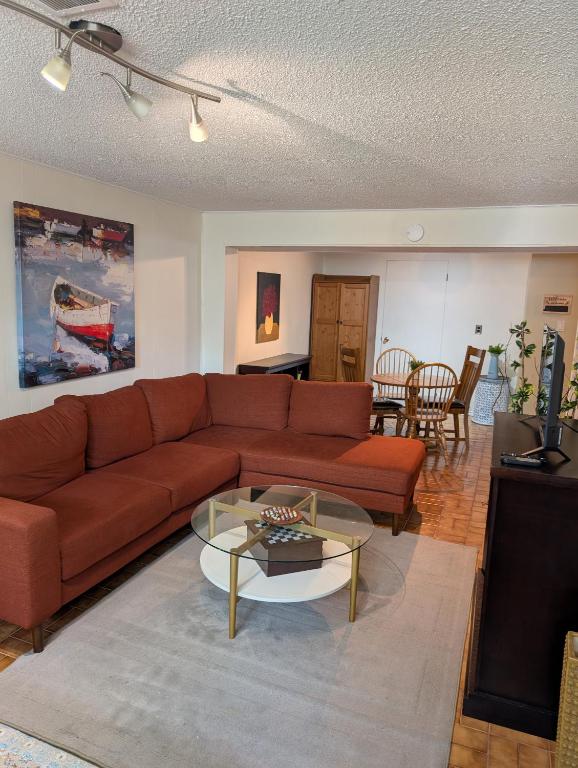 a living room with a couch and a table at West End Basement Apartment in Toronto