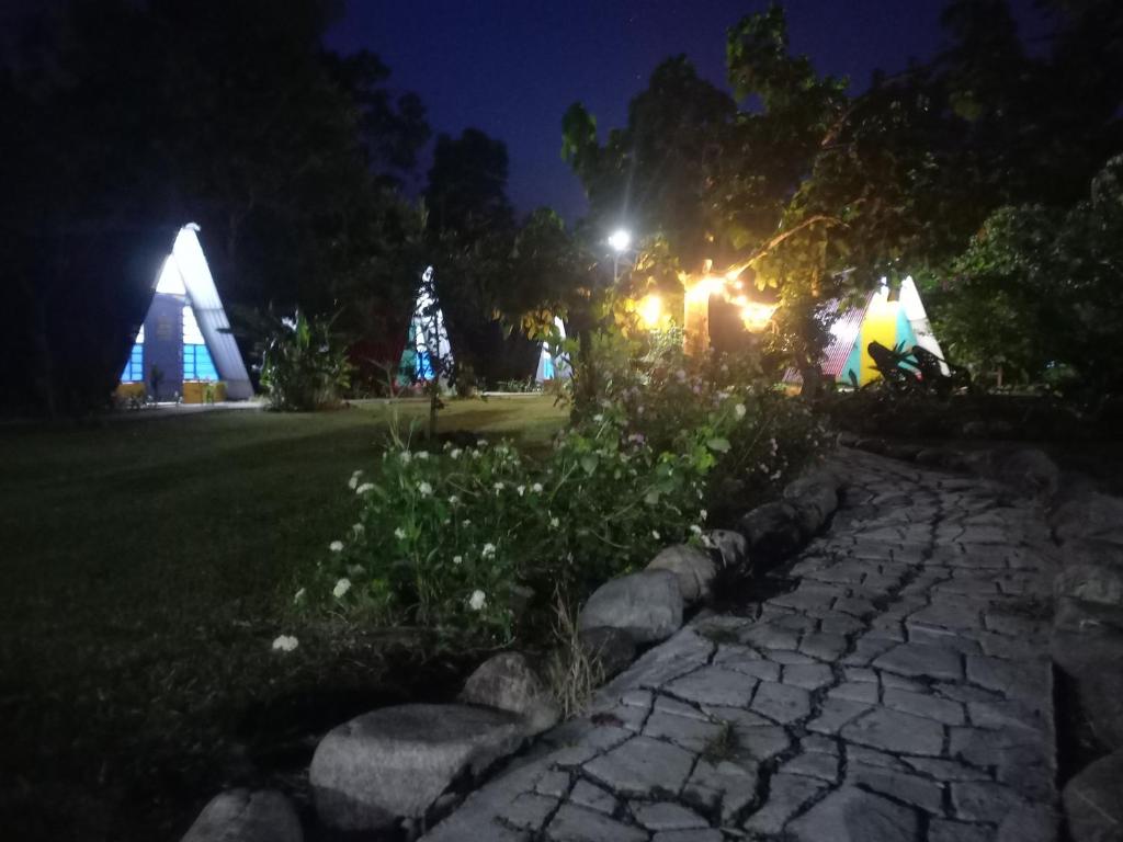 a stone path at night with a building in the background at Casa del Bosque in Mocoa