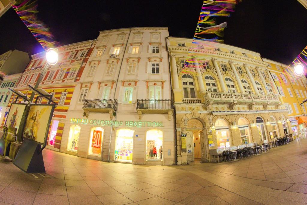 a large building on a city street at night at Apartment Jasmin in Rijeka