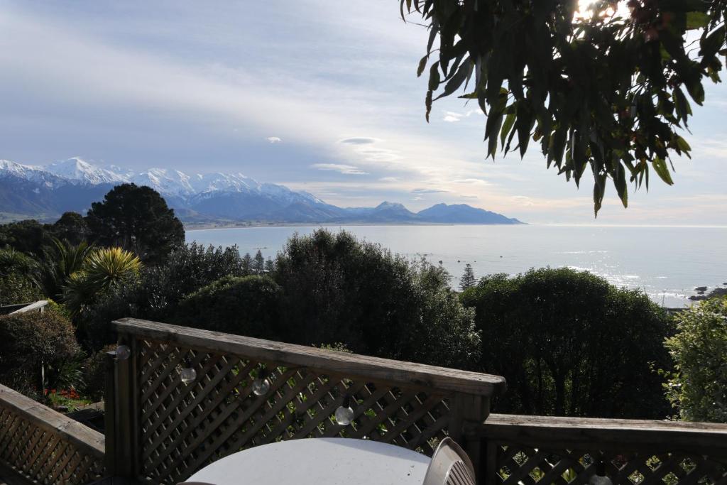 a view of the water and mountains from a house at Spectacular Views, Convenient, Affordable - KK17129 in Kaikoura