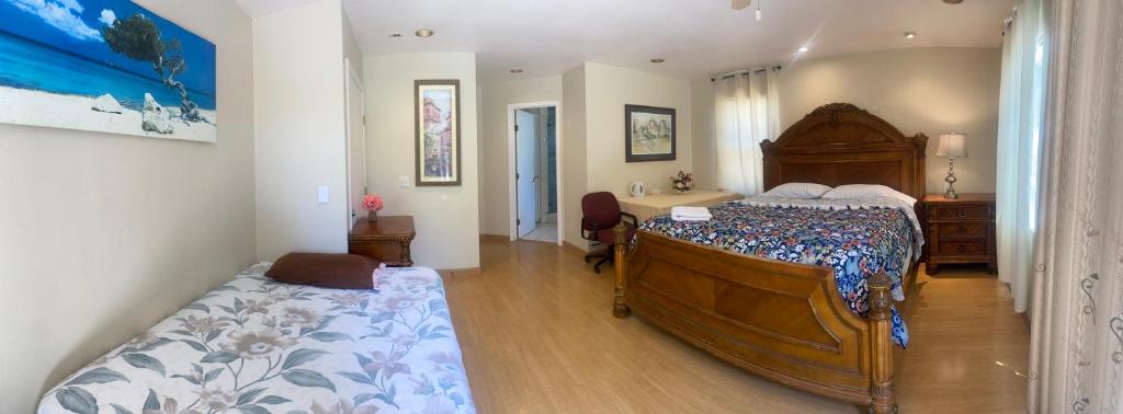 a bedroom with a large wooden bed and a desk at WM Private master suite with separate entry in San Jose
