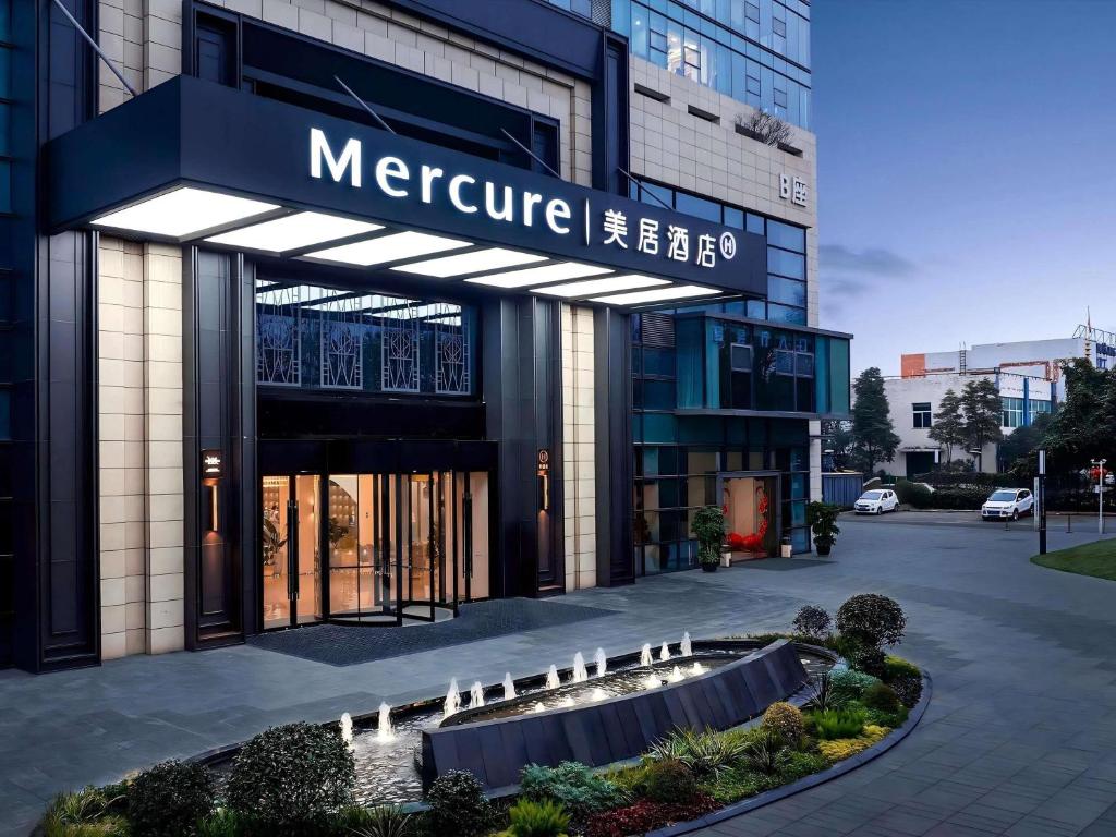 a large building with a sign on the front of it at Mercure Chengdu Longtan in Chengdu