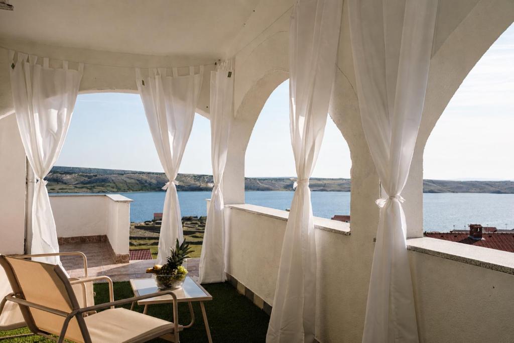 a balcony with a view of the water at Villa Grubešić - Sea View Apartments in Kustići