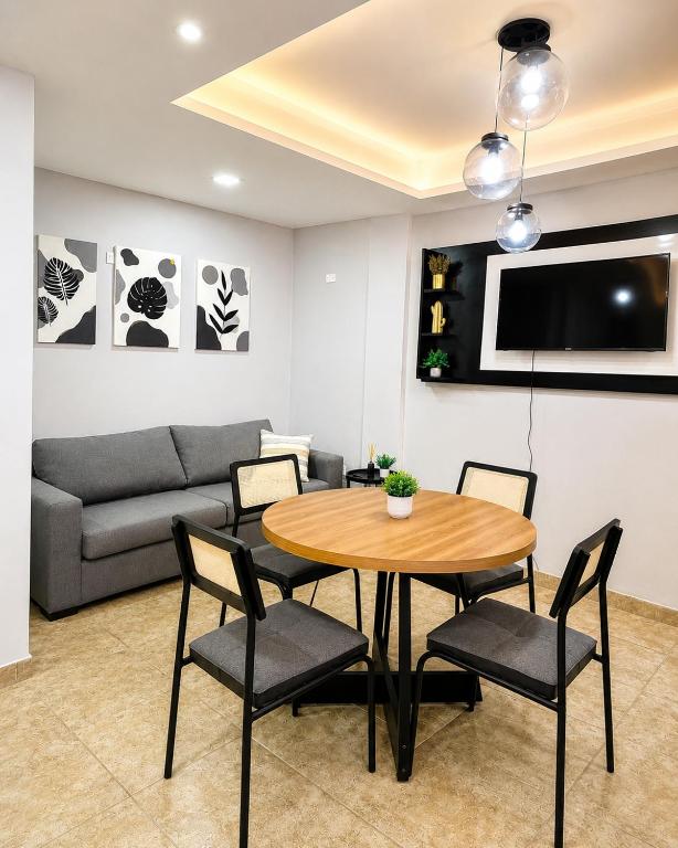 a living room with a table and chairs and a couch at Paramont Rosario 2 in Rosario de la Frontera