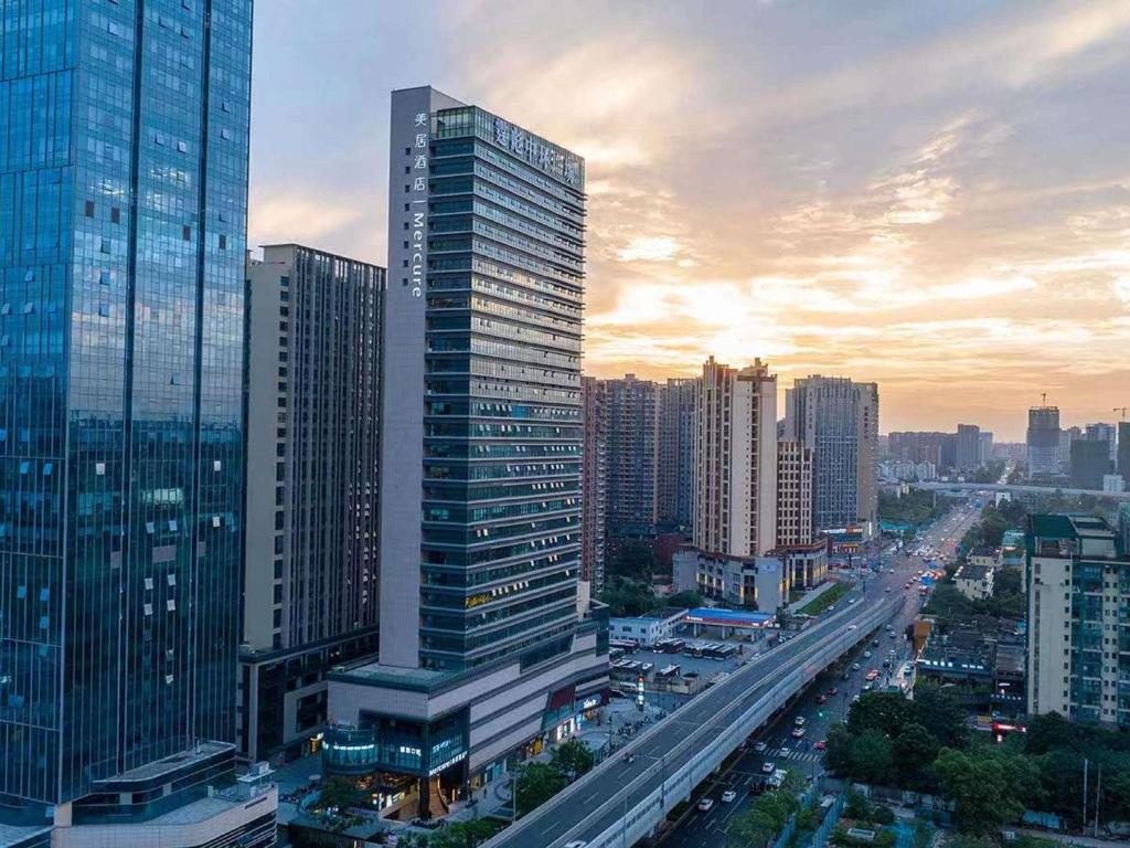 a city skyline with tall buildings and a highway at Mercure Chengdu Dongjiao Memory in Chengdu