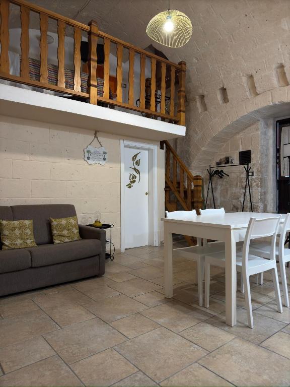 a living room with a white table and a couch at More Apartments il castello in Bari