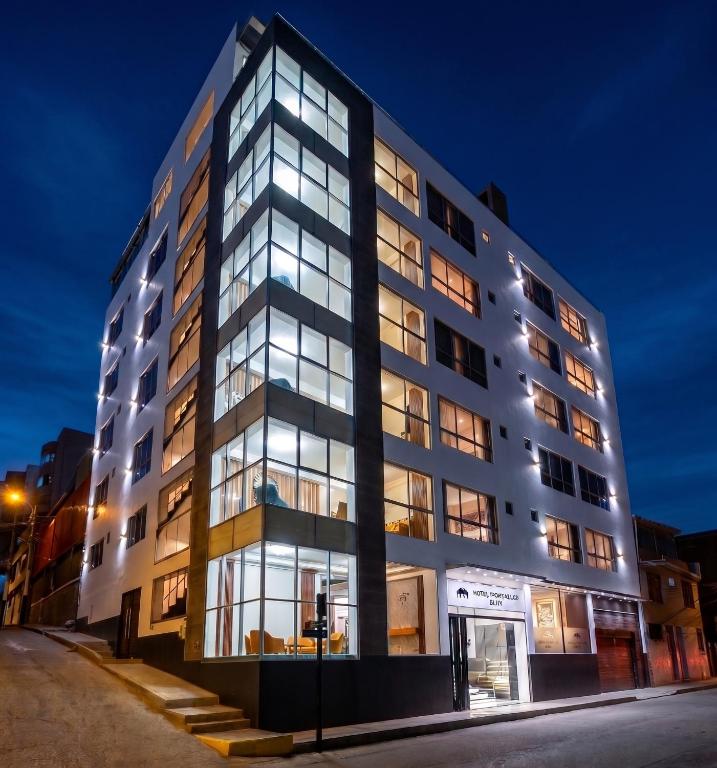 a tall building with many windows at night at Hotel Yanahuara Suite in Arequipa