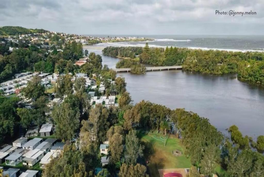 an aerial view of a river with houses and trees at Discovery Parks - Gerroa in Gerroa