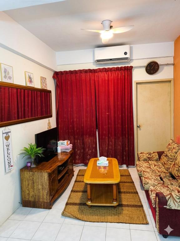 a living room with a couch and a table at MonoStay Samarahan in Kota Samarahan