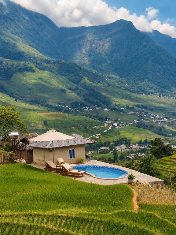 a villa with a swimming pool in the middle of a mountain at Best View Homestay in Sapa