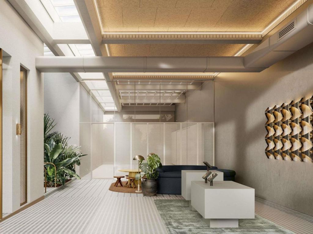 a lobby with a white table and some plants at Novotel St Kilda in Melbourne