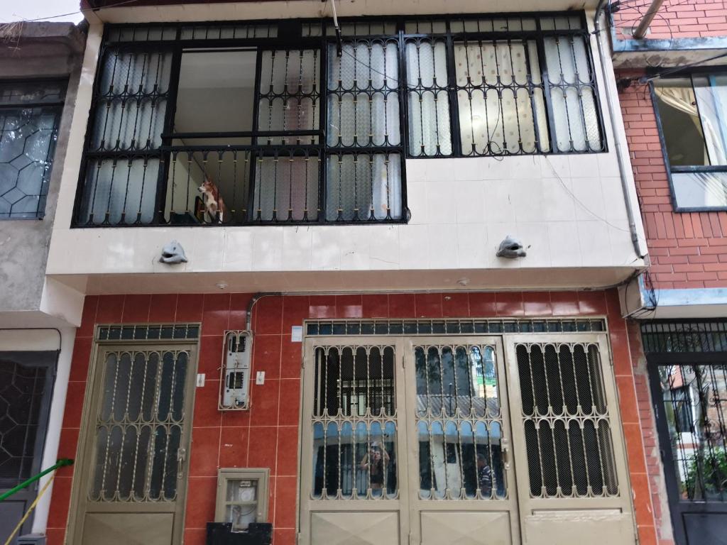 a building with barred windows on the front of it at Felipe's House in Ibagué