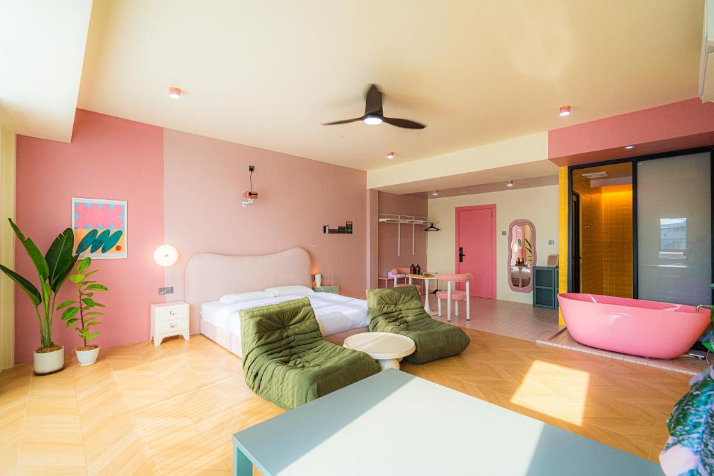 a bedroom with a bed and a bathroom with a tub at Lot 78 in Malacca