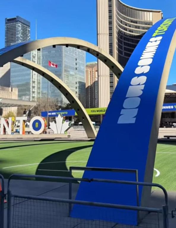 a view of a stadium with a bridge in the city at City Centre Suite, Steps to UofT, TMU, Yonge-Dundas Square in Toronto