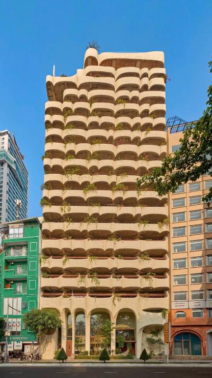 a tall building with plants on the side of it at Ibala Hotel & Spa in Nha Trang