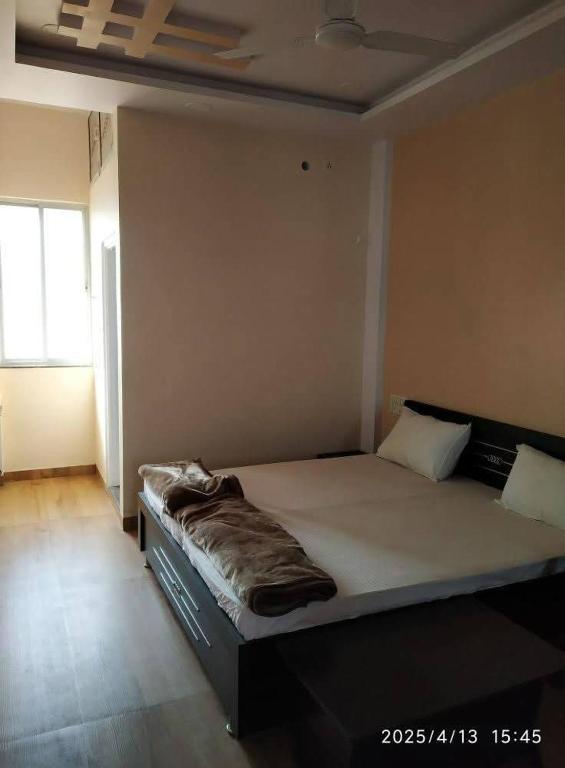 a bedroom with a large bed in a room at Adharshila hotel & Dormitory in Shahdol