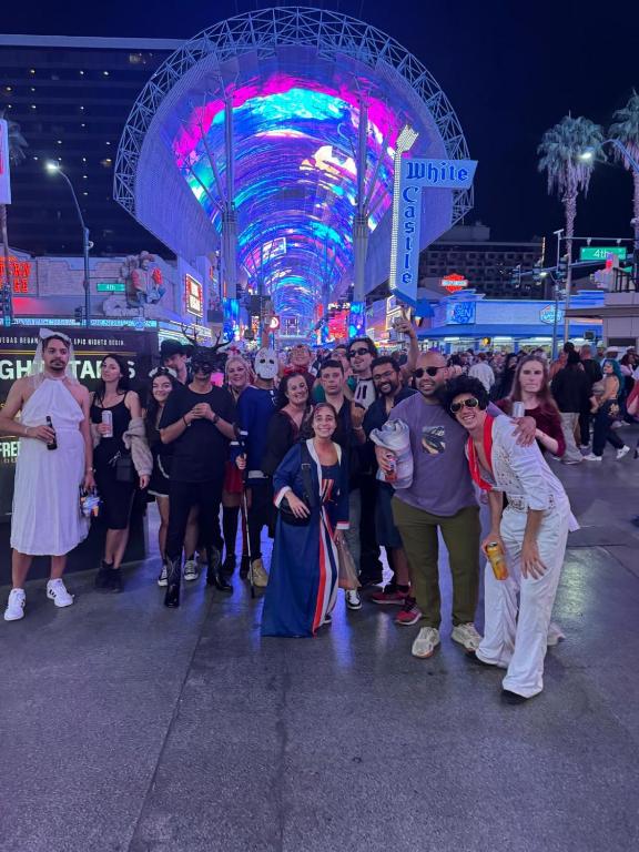 a group of people standing in a street at night at Sin City Hostel in Las Vegas